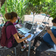 East College Prep High School senior Jocelyn Hernandez follows a remote Advanced Placement (AP) Calculus class as her cousin plays with his phone while sitting in a community garden near her home, August 14, 2020 in the Boyle Heights neighborhood of Los Angeles, California.